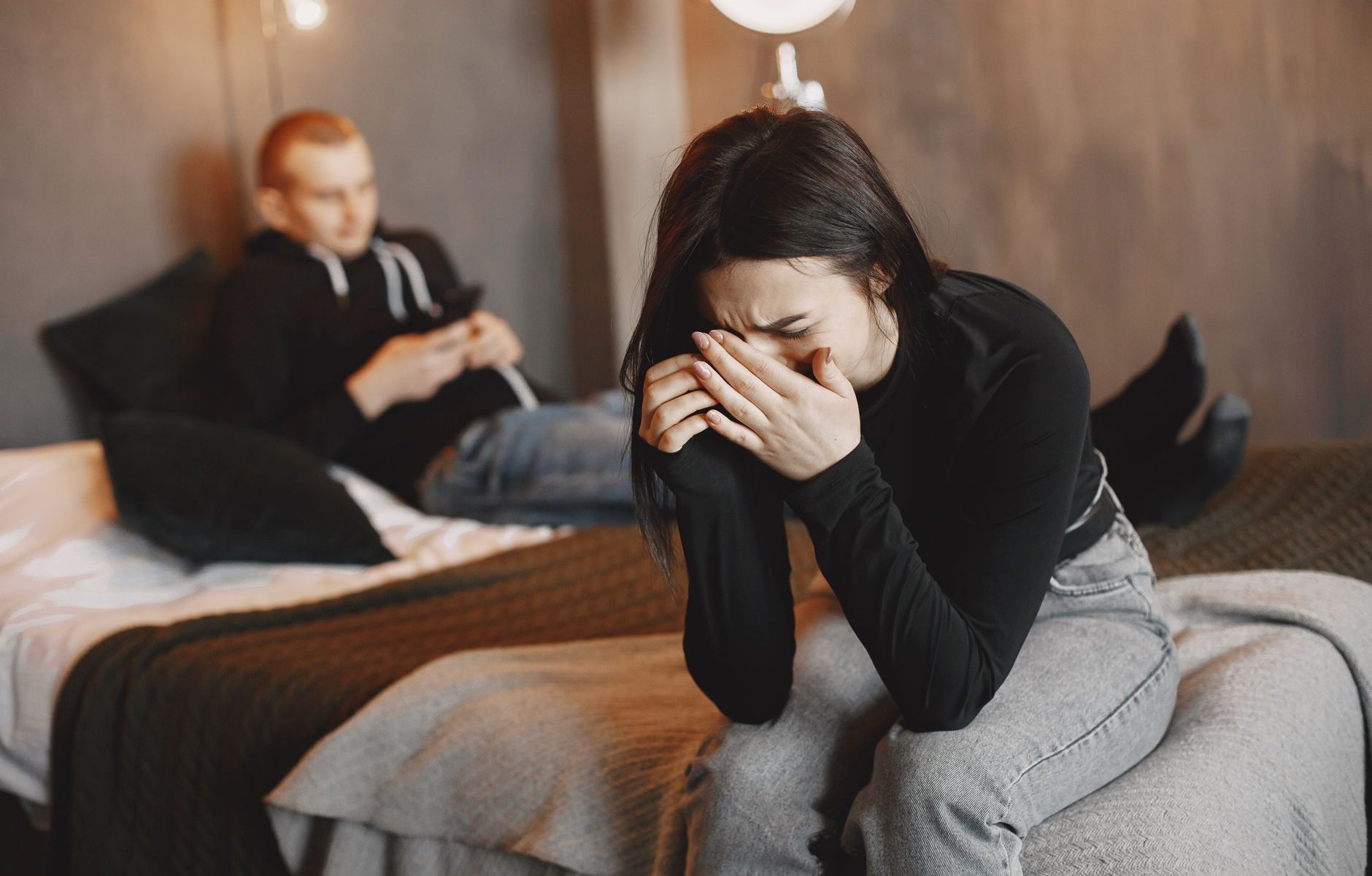 photo of a woman in a black top crying